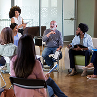 Mature man shares his ideas during a community meeting